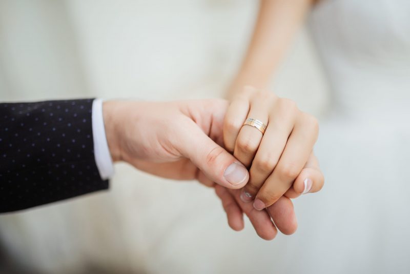 Wedding moments. Newly wed couple’s hands with wedding rings